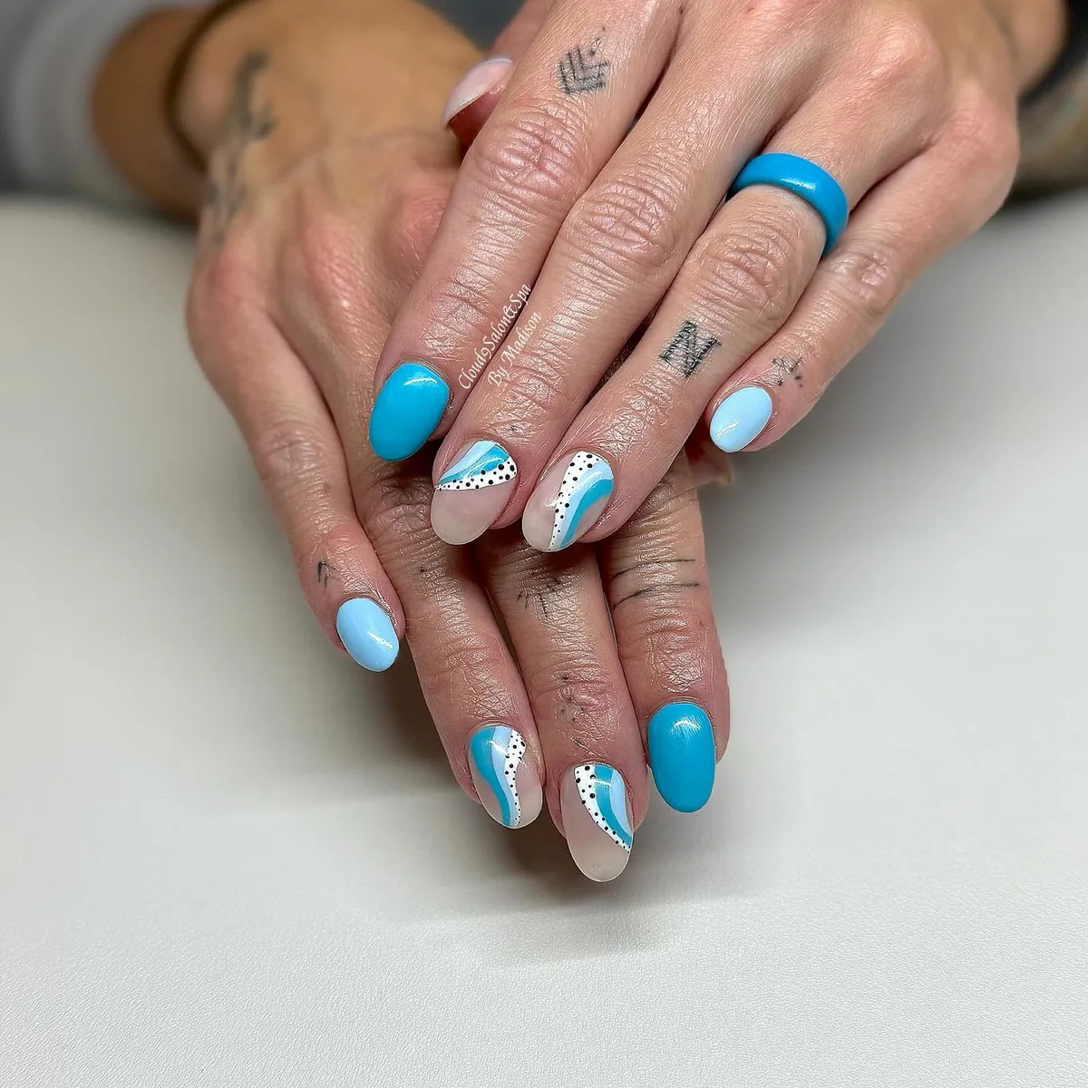 Turquoise and light blue curves with dotted accents