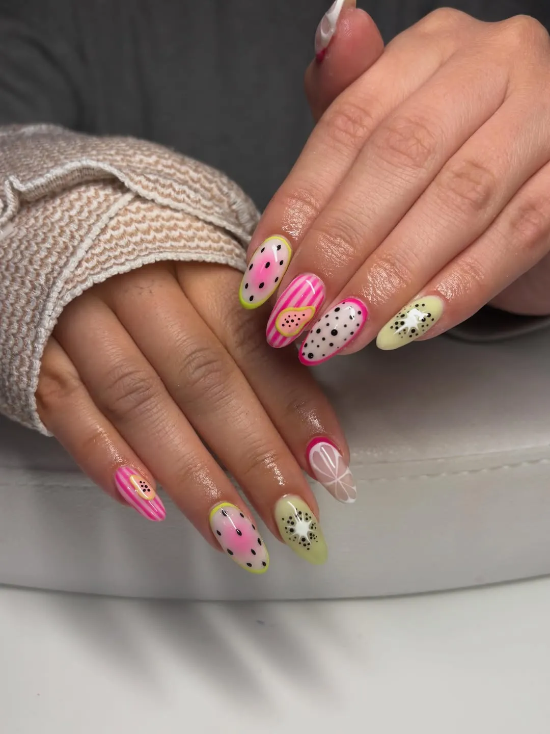 Mixed fruit-slice and seed-dot nail art